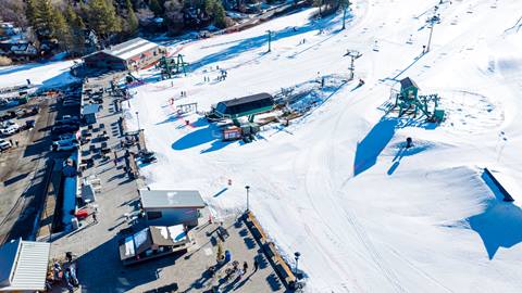Drone photo of the base area including the sun deck and The Scene terrain park at Bear Mountain 