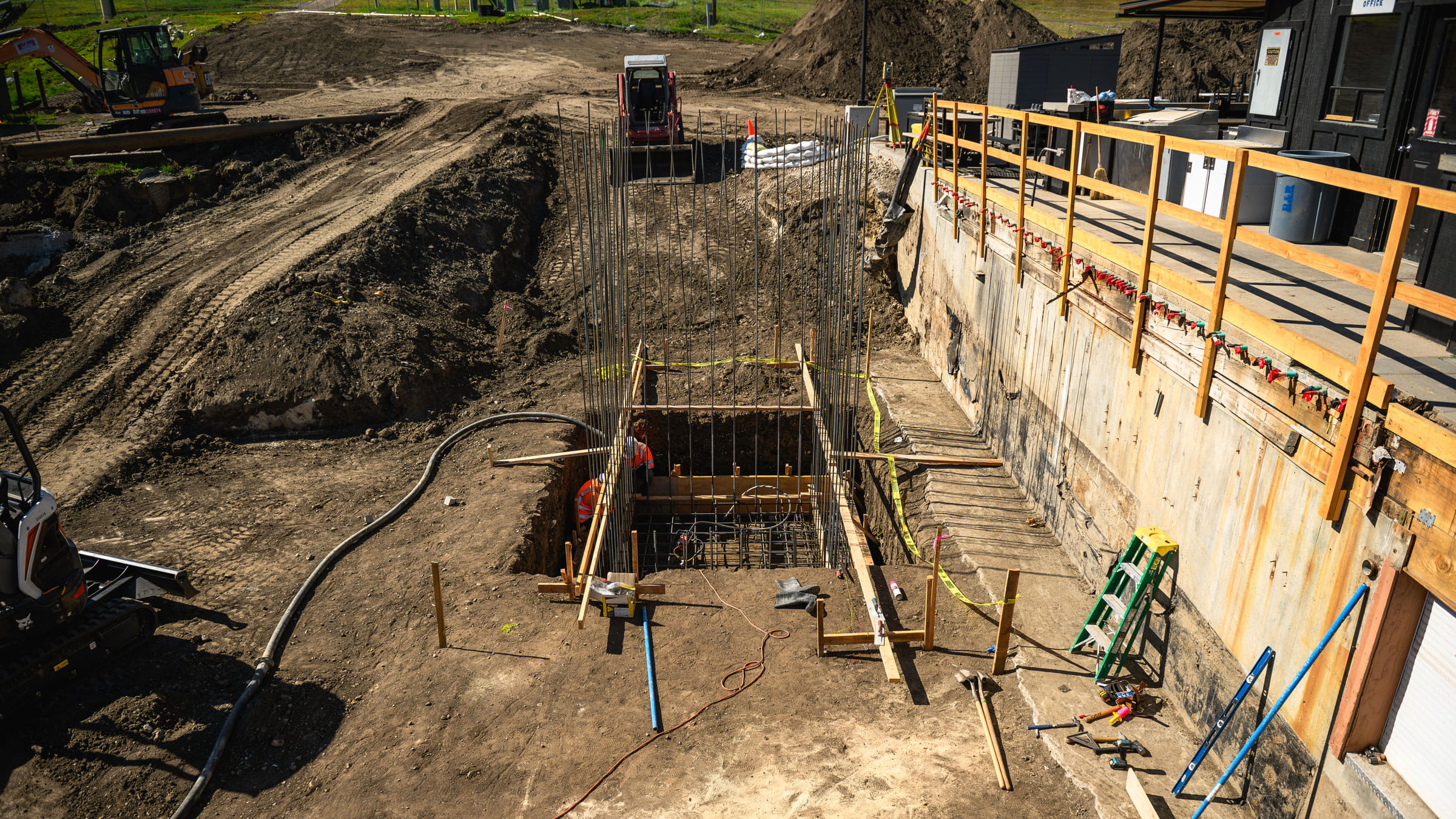 Construction ground work with dirt, metal, and wood features.