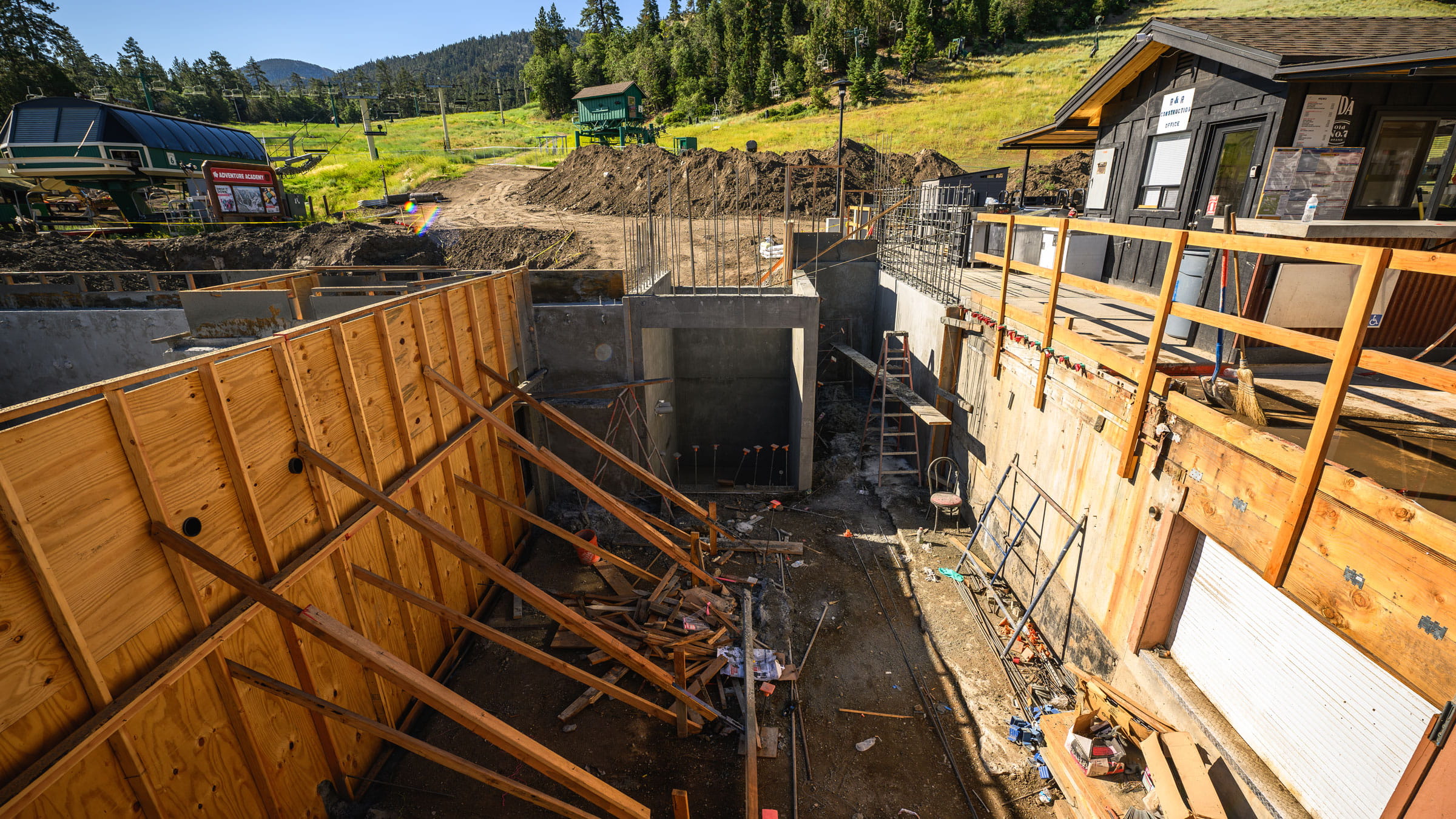 Ariel view of ground construction with wooden walls being supported by wood planks.