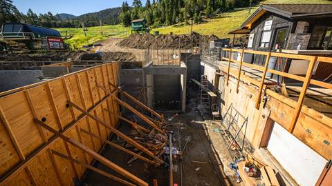 Ariel view of ground construction with wooden walls being supported by wood planks.