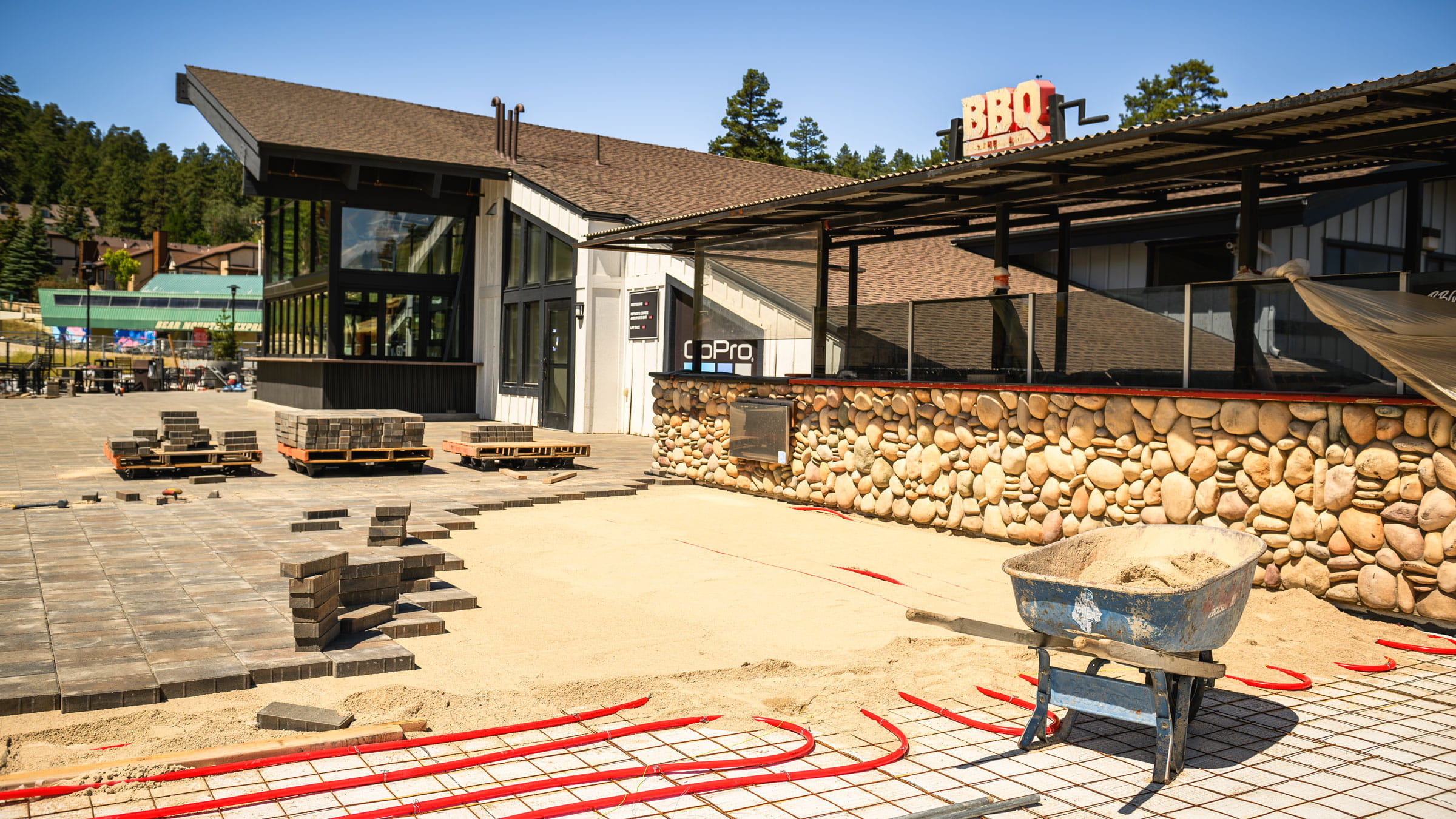 Pavers being laid out in front of outdoor restaurant.