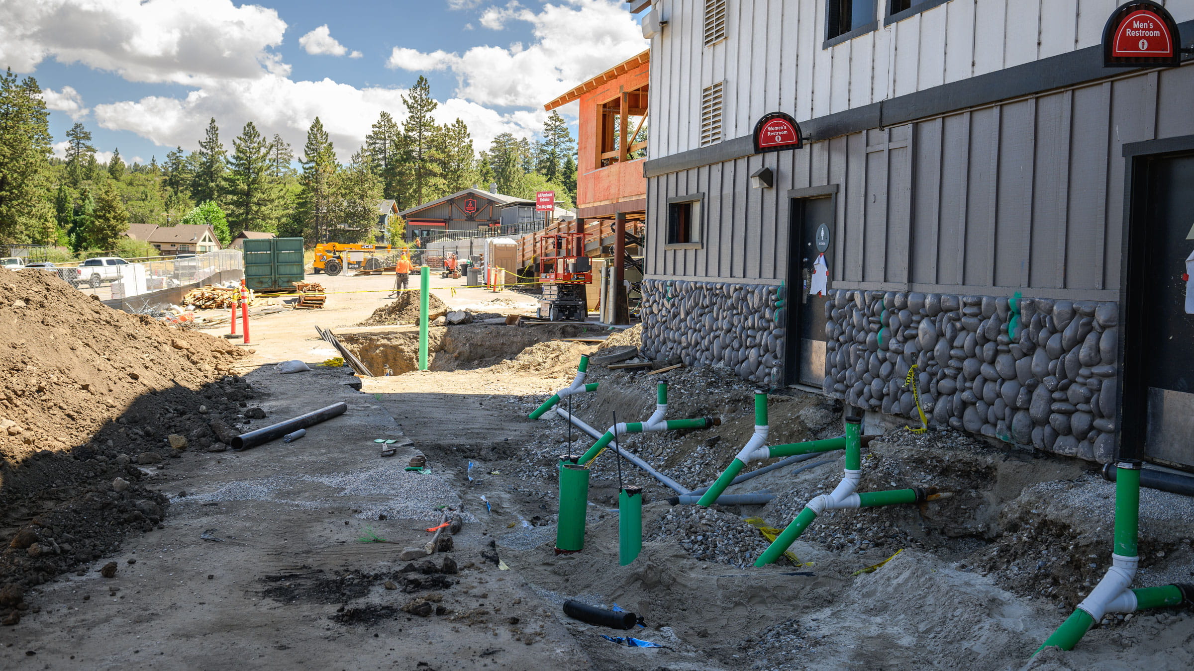 Outdoor construction on main level near parking lot. A lot of moving dirt around.