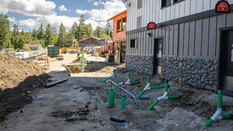 Outdoor construction on main level near parking lot. A lot of moving dirt around.