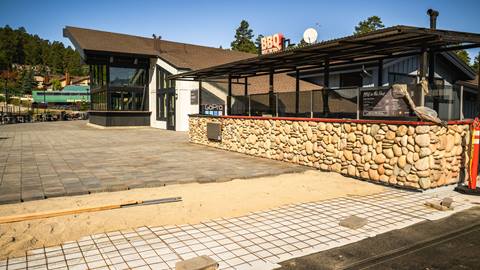Outdoor decking nearly finished with pavers being laid out.