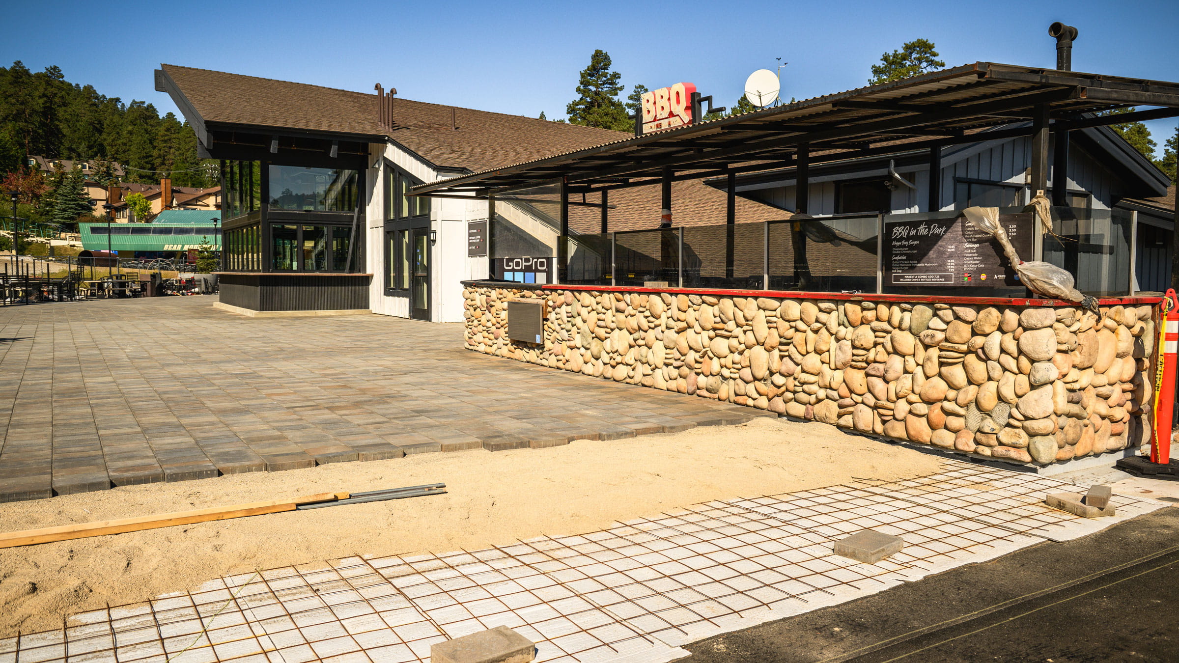 Outdoor decking nearly finished with pavers being laid out.