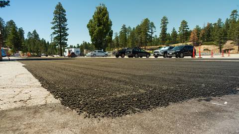 Small finished section of the Snow Valley parking lot with new asphalt.