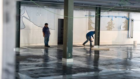 remodel inside of snow valley's rental shop with two construction workers in the background