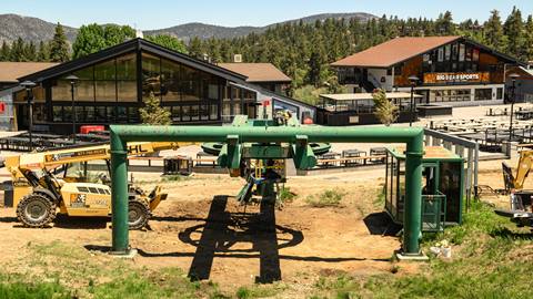 Bear Mountain sundeck during the summer time with a construction forklift and excavator working on the bottom chairlift overhaul project.