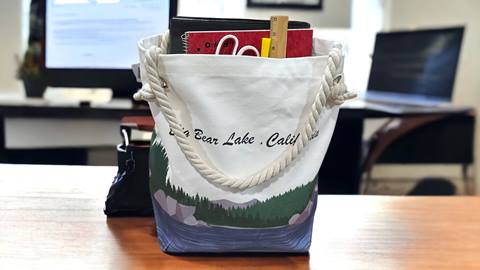 Big Bear Lake branded tote bag with school items inside it