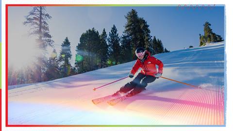 Female skier going downhill on a ski slope with a rainbow overlay on the photo