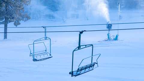 active snowmaking on a ski slope at big bear mountain resort with chairlifts in the middle of the shot