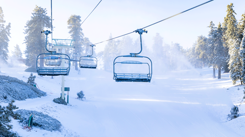 active snowmaking on a ski slope at big bear mountain resort with chairlifts in the photo