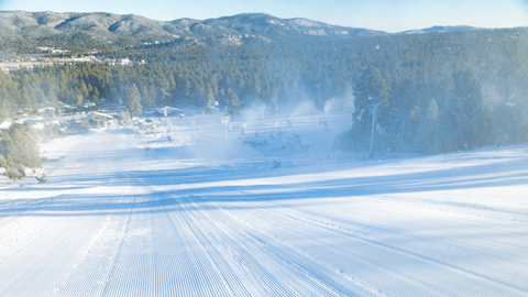 active snowmaking on a ski slope at big bear mountain resort on a freshly groomed ski run