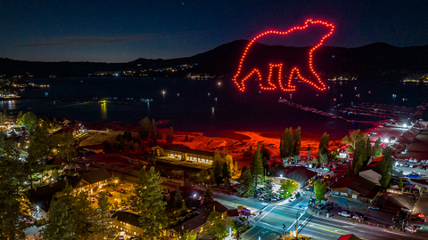 Drone show in Big Bear Lake with a red bear made from drone at night