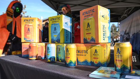 Boxes and cans of Athletic Brewing on a table