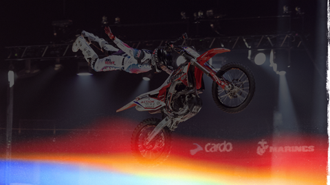 Motorcyclist doing a trick in the air during a nitro circus performance