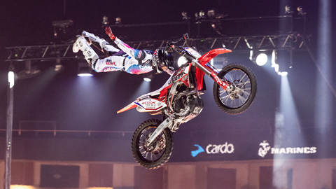 Motorcyclist doing a trick in the air during a nitro circus performance