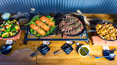 Layout of food including salmon, tri-trip, and sides