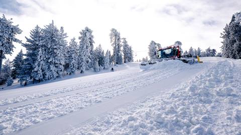 A snow cat grooming a trail after a winter storm provided fresh new snow.
