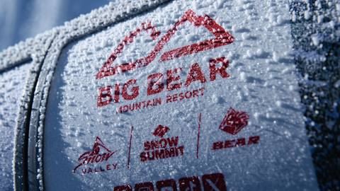 The BBMR logo with a dusting of snow on the chairlift pull down safety bar.