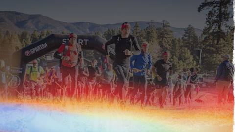 A group of Spartan racers dashing out of the the start gate.