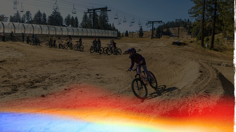 Child mountain biking with a group of other youth bikers at Snow Valley during the MTB Camp weekend.