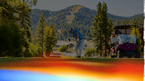 golfer swinging on the course with Geronimo in the background