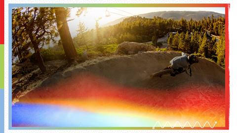 mountain biker on a downhill trail with the photo overlay with rainbow colored tint