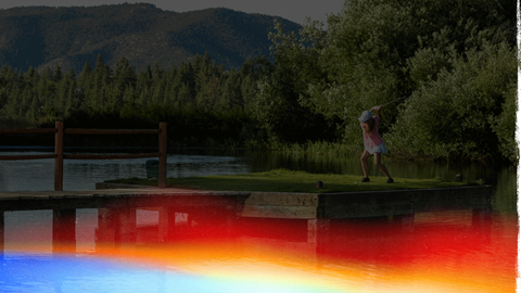 Female golfer hitting ball near a pond