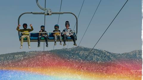 four mountain bikers on a chairlift