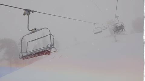 Chairlift shot during a winter snow storm