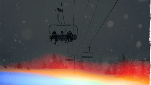 Snowy ride with snowboarders on a chairlift at Snow Valley