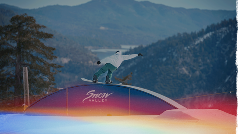 snowboarder at snow valley doing a rail trick