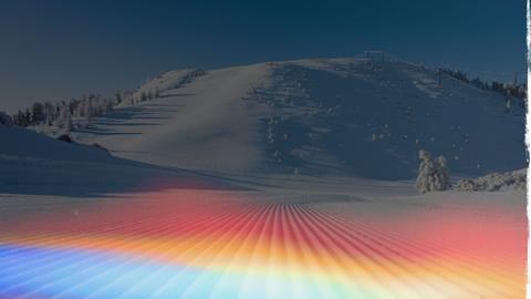 Groomed corduroy trail with Snow Valley's Slide Peak in the background on a blue bird sunny day after a snow storm.