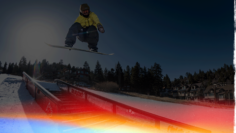 snowboarder doing a trick off a stairs park feature