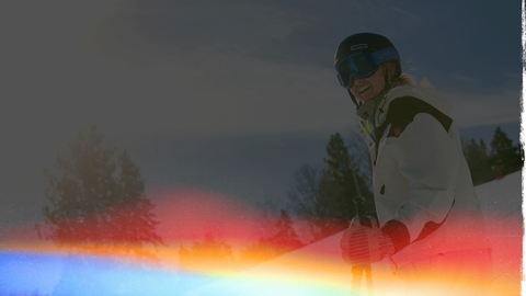 skier on the ski slope taking a break and smiling