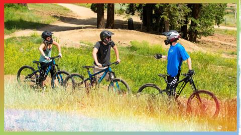 two adults taking a mtb lesson, instructor giving instructions