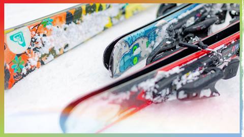 Three pairs of skis laying on the snow