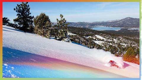 Snowboarder with a long carving slash in fresh powder