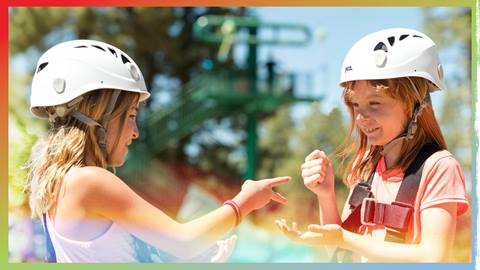 Two kiddos playing ro sham bo with zipline helmets on
