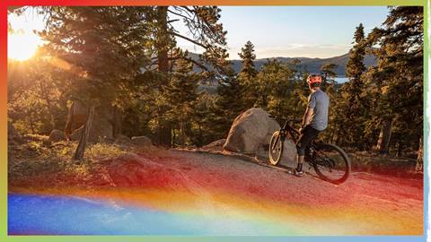 mountain biker overlooking big bear lake from the top of the mtb trail