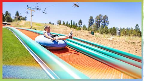 Young kid riding down a tube lane at Grizzly Ridge Tube Park