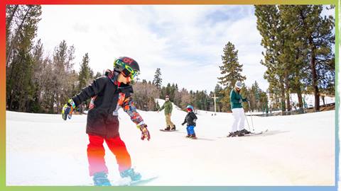 Family skiing and snowboarding on the slopes