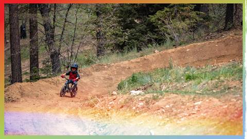 Kiddo on mountain bike riding along a dirt trail