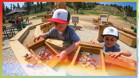 Two kids enjoying rocks and minerals at the Summit Mining Co.