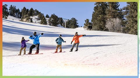 group of snowboarders taking a lesson with a professional instructor at Snow Summit on a sunny day