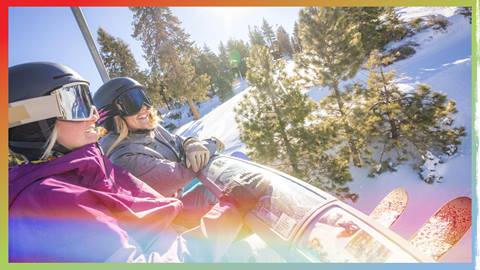 two skiers on the chairlift