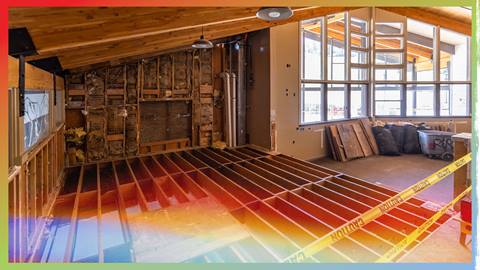Construction workers with orange cones demolitioning an indoor deck