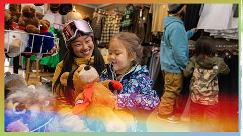 mom and daughter a snow summit's sports shop shopping for a teddy bear plush
