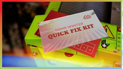 BBMR Winter Quick Fix Kit wax card lying on top of a snowboard and machine